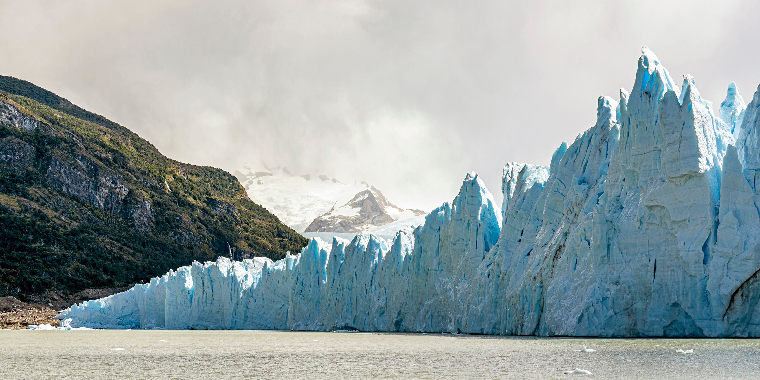 Water, Glacier, Trees, Mountains, Clouds Argentina's Perito Moreno glacier is simply stunning. Although you can't tell from this photo, the glacier comes down for miles...