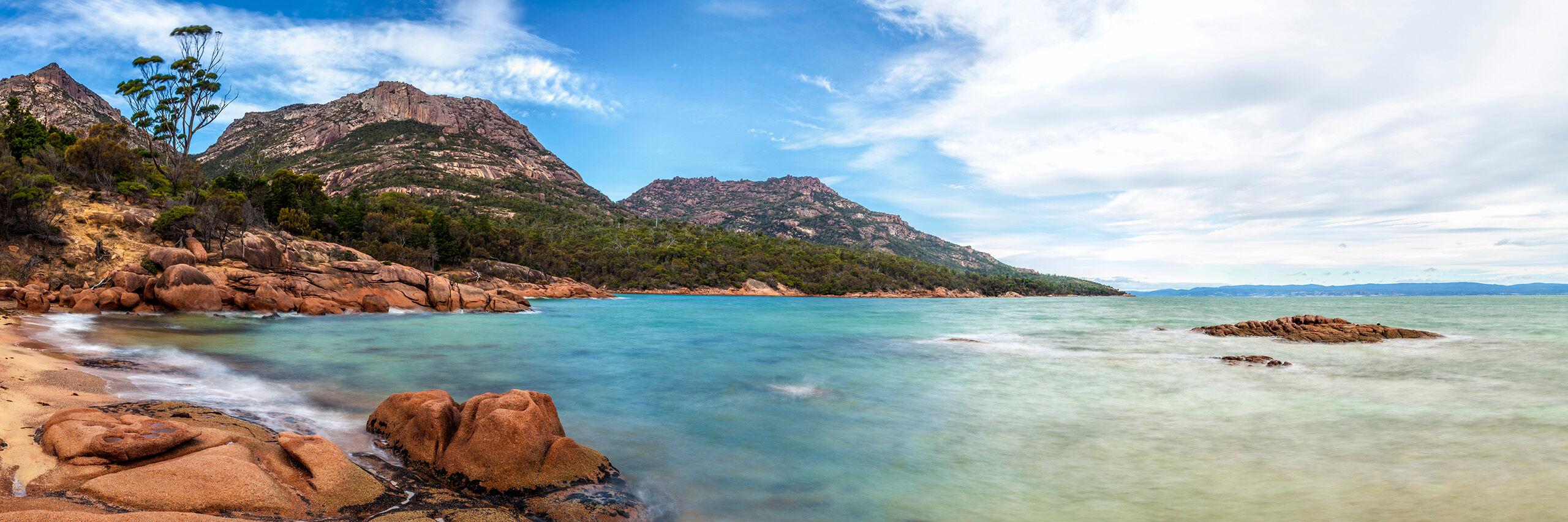 Honeymoon Bay Freycinet National Park, located on a small peninsula on the east coast of Tasmania, Australia, is extremely photogenic. Orange...