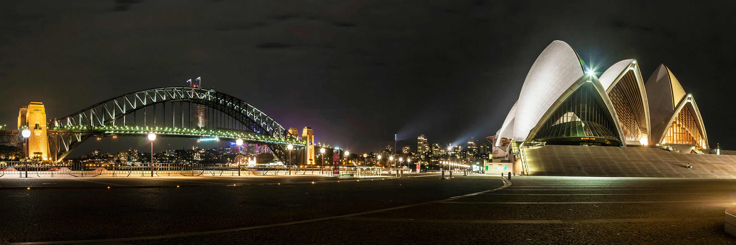 Nighttime in Sydney Night time at the Sydney Opera House and the Sydney Harbor Bridge, the world's largest steel arched bridge. An Australian icon...
