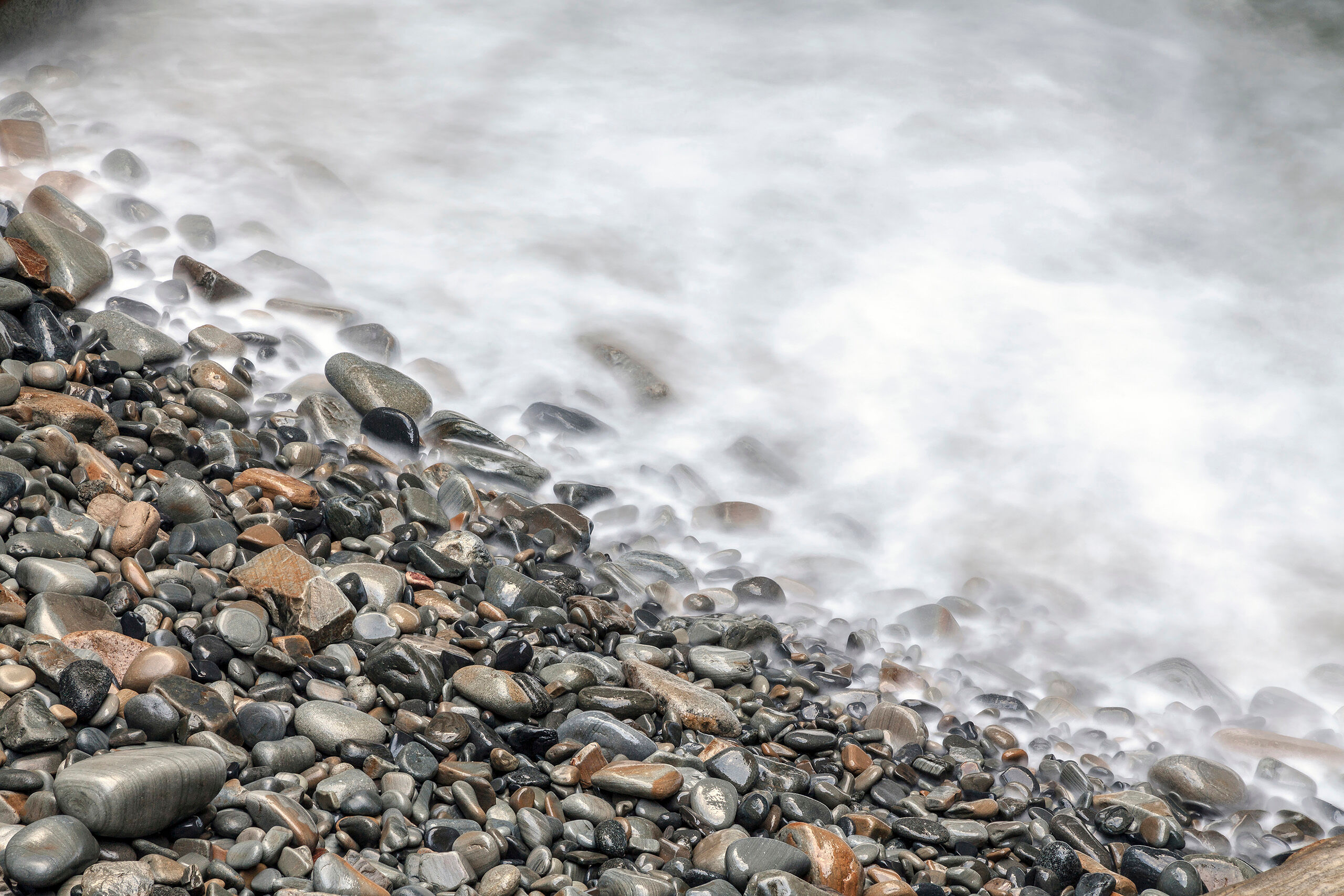 Smooth Stones It took me several attempts to get this photo composed as it is seen here. The ghostly looking water in is the result of a wave...