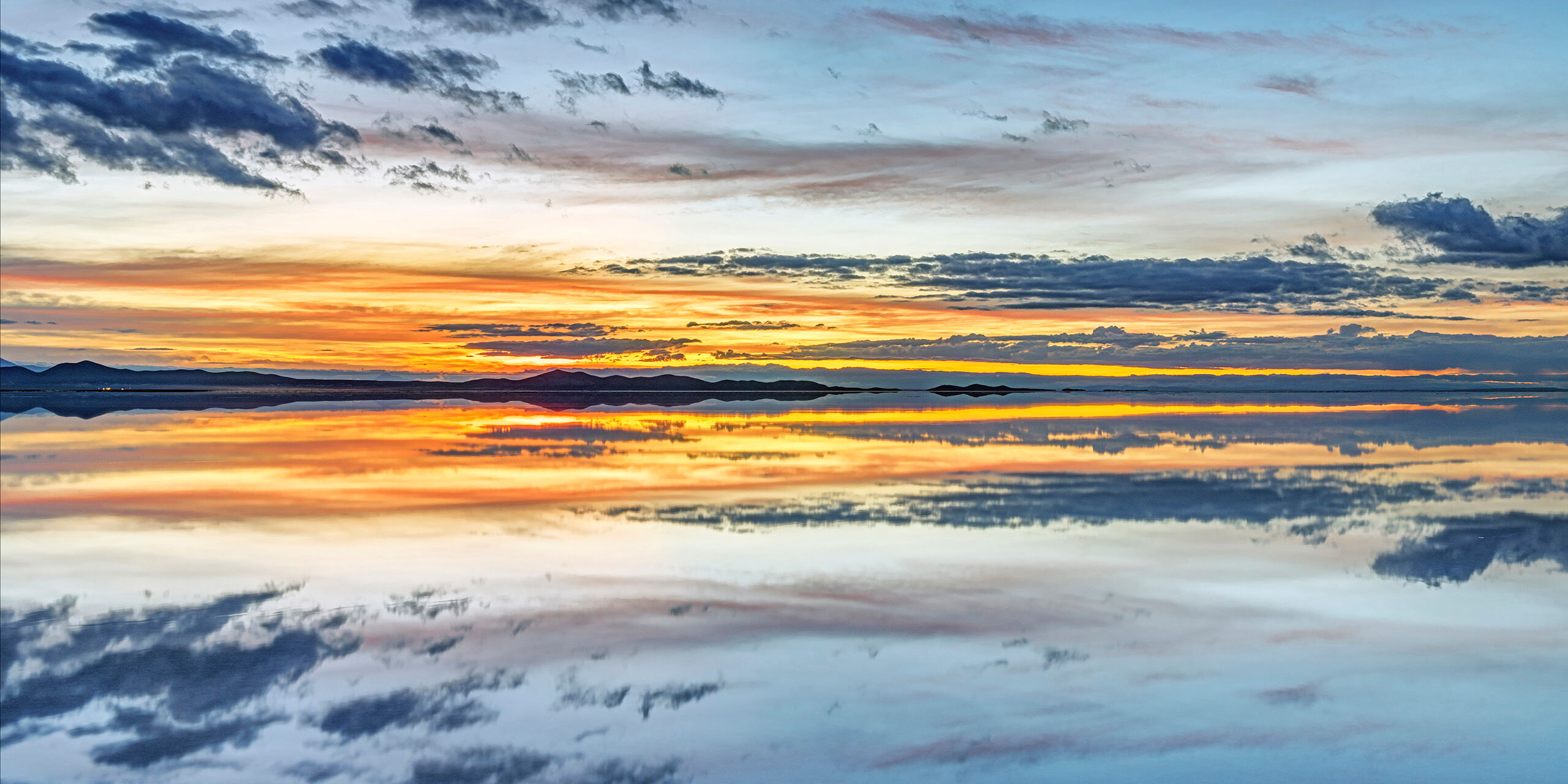 Colorful Reflection Sitting at roughly 12,000 feet above sea level, the Salar de Uyuni is, at over 3,900 square miles, the world's largest salt flat...