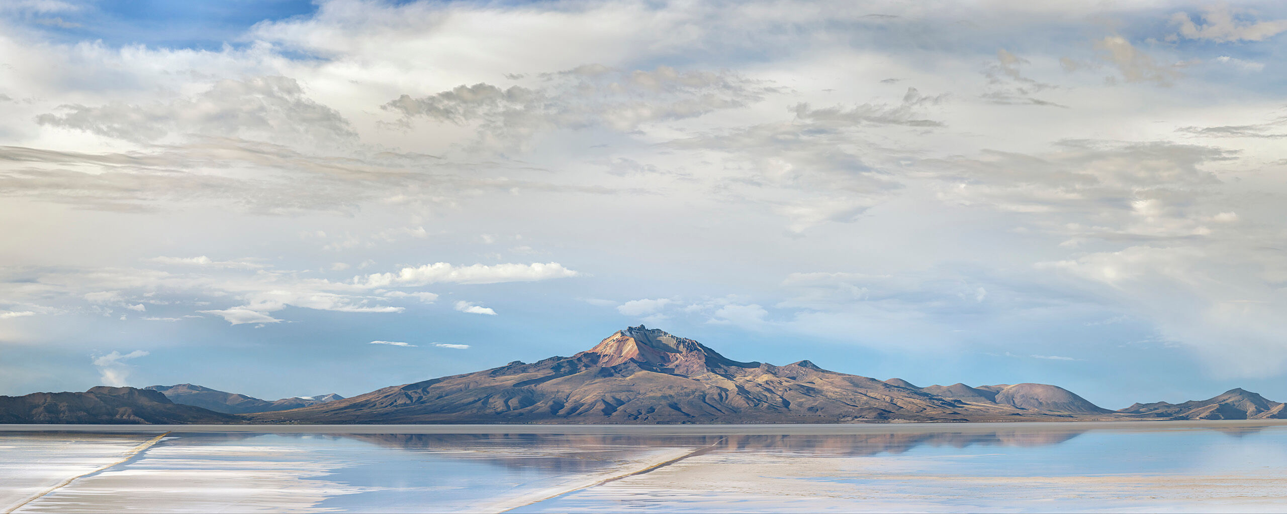 Tunupa Panorama Southwest Bolivia's dormant Volcàn Tunupa, which reaches an elevation of 17,457 feet, lies at the northern edge of el...