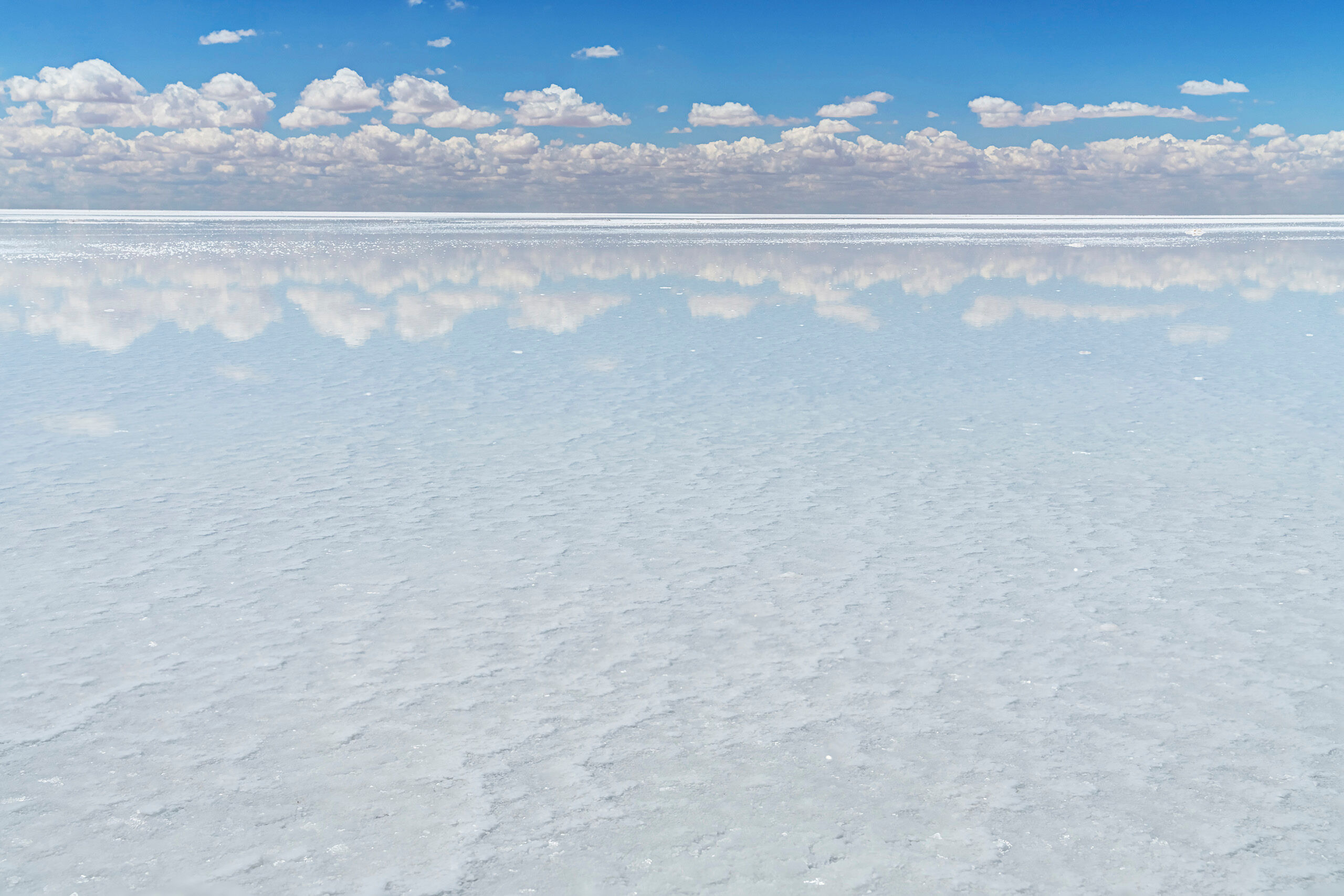 Uyuni Reflection Sitting at roughly 12,000 feet above sea level, the Salar de Uyuni is, at over 3,900 square miles, the world's largest salt flat...