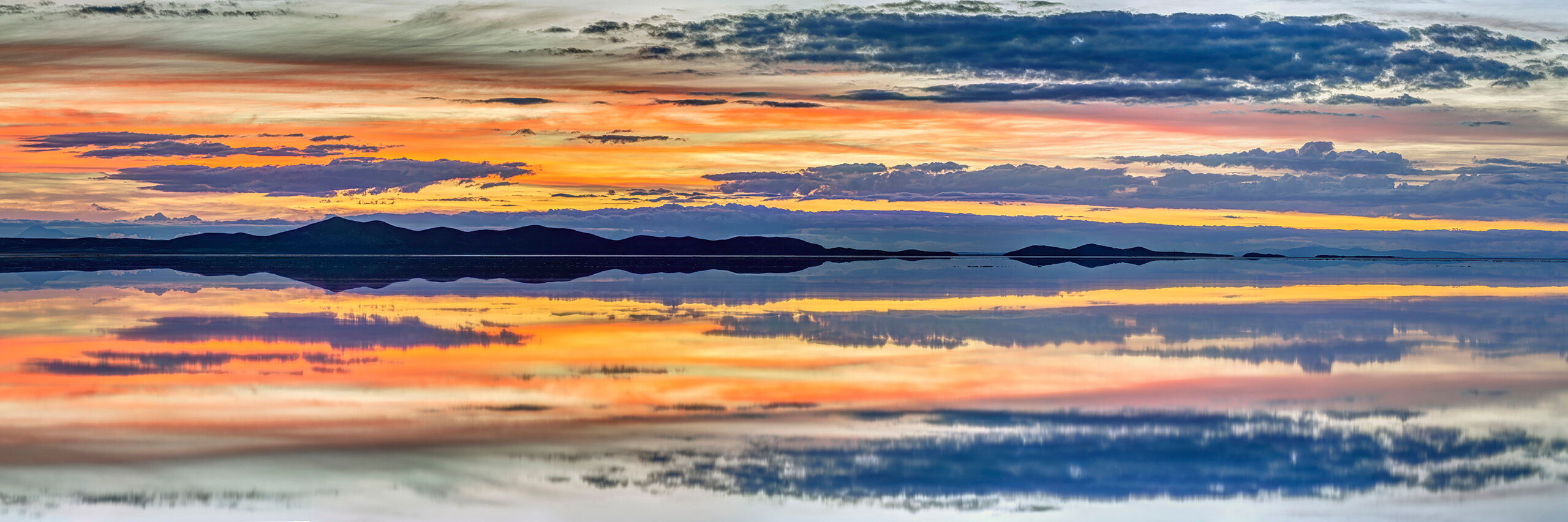 Uyuni Sunrise Panorama Sitting at roughly 12,000 feet above sea level, the Salar de Uyuni is, at over 3,900 square miles, the world's largest salt flat...