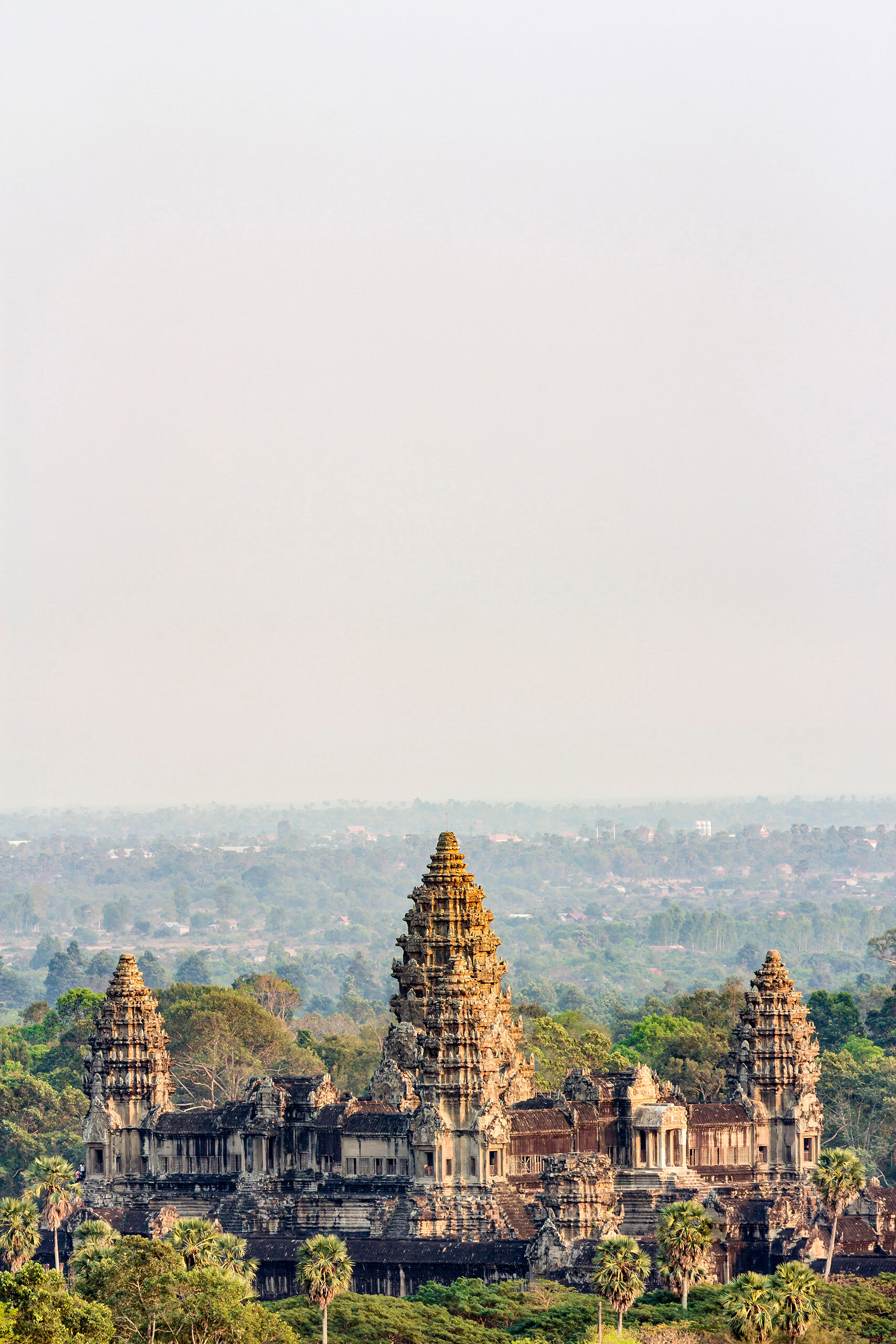 Angkor Wat Portrait Angkor Wat as seen from Phnom Bakheng at dusk. The nearly constant haze makes seeing anything in the region difficult from a...