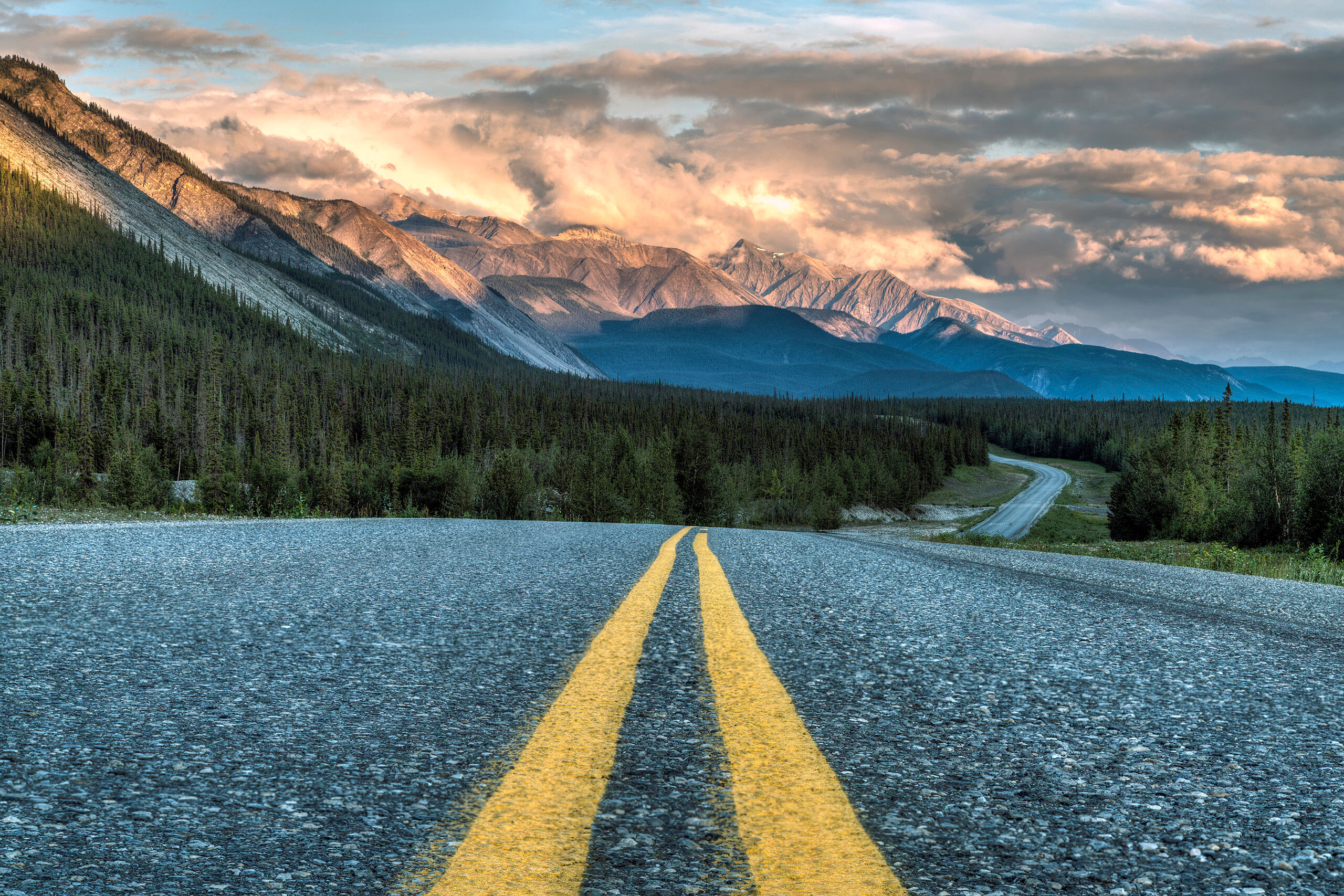 Sunset on the Alcan Highway Although the southern portion of the Canadian Rockies – the Banff and Jasper area, specifically – receive the lion...