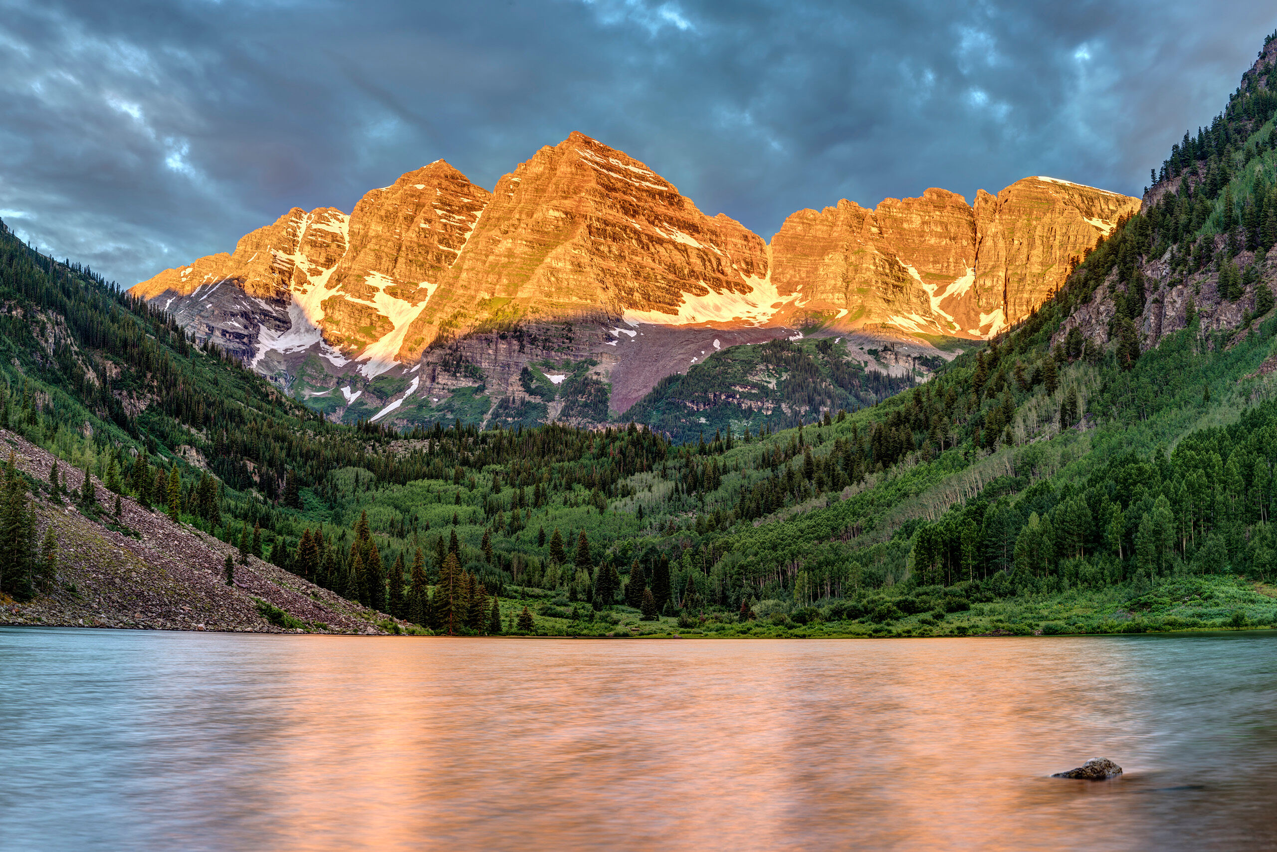 Summer Sunrise at the Maroon Bells The Maroon Bells are touted as the most photographed spot in Colorado. I'm not sure this is correct, but they are absolutely...