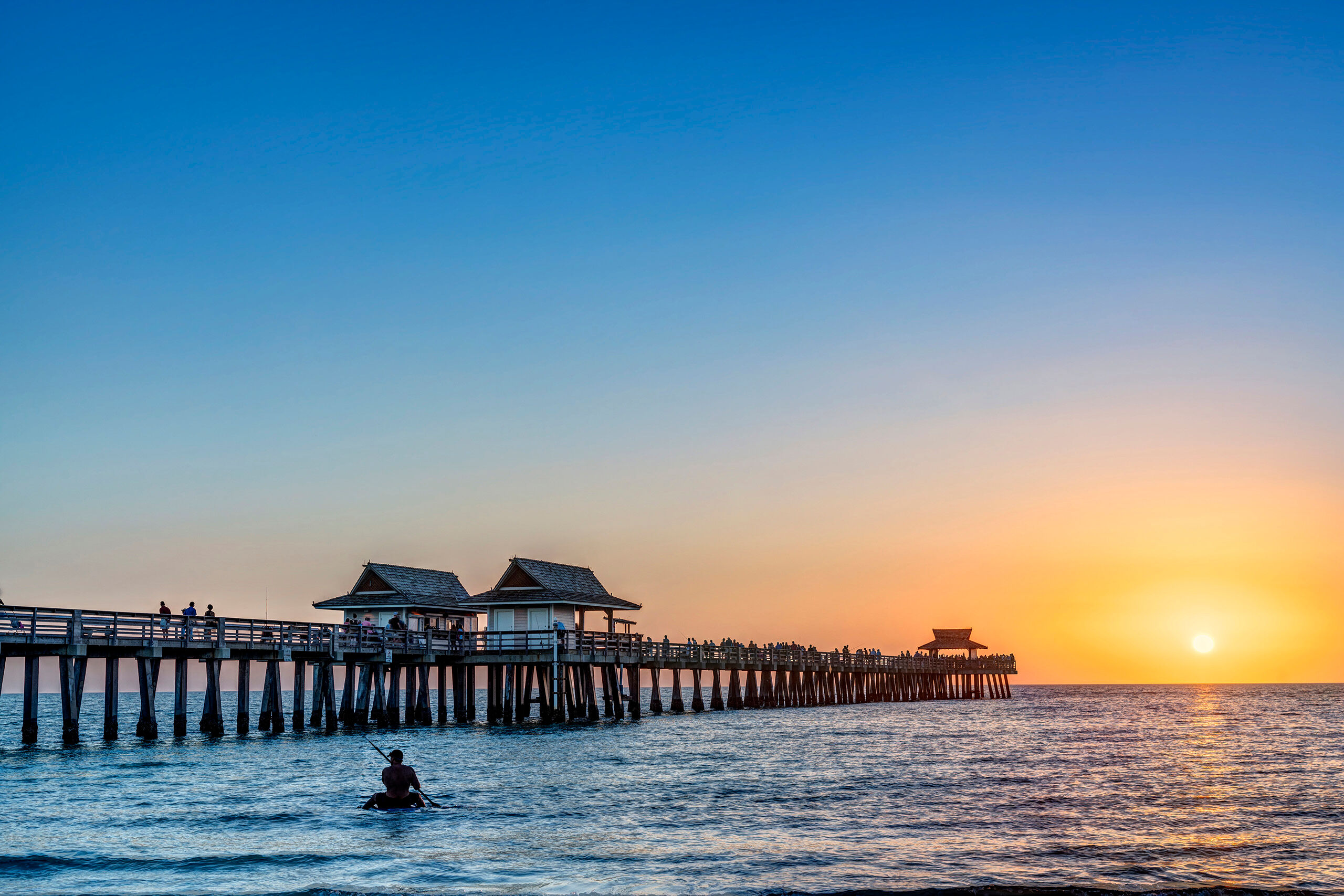 Sunset at Naples Pier Hundreds of tourists visit Naples Pier and the surrounding beach each and every sunset during tourist season – weather...
